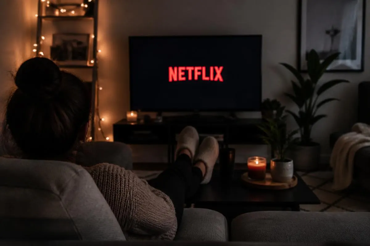 A person on a couch watching television instead of working